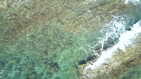 oceanscape, rocky tide pools with beautiful turquoise ocean water - aerial drone overhead view