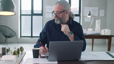 Senior-Architect-Working-at-Desk-in-Office