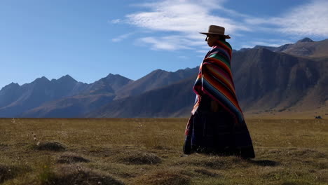 woman in traditional attire in a vast mountainous landscape