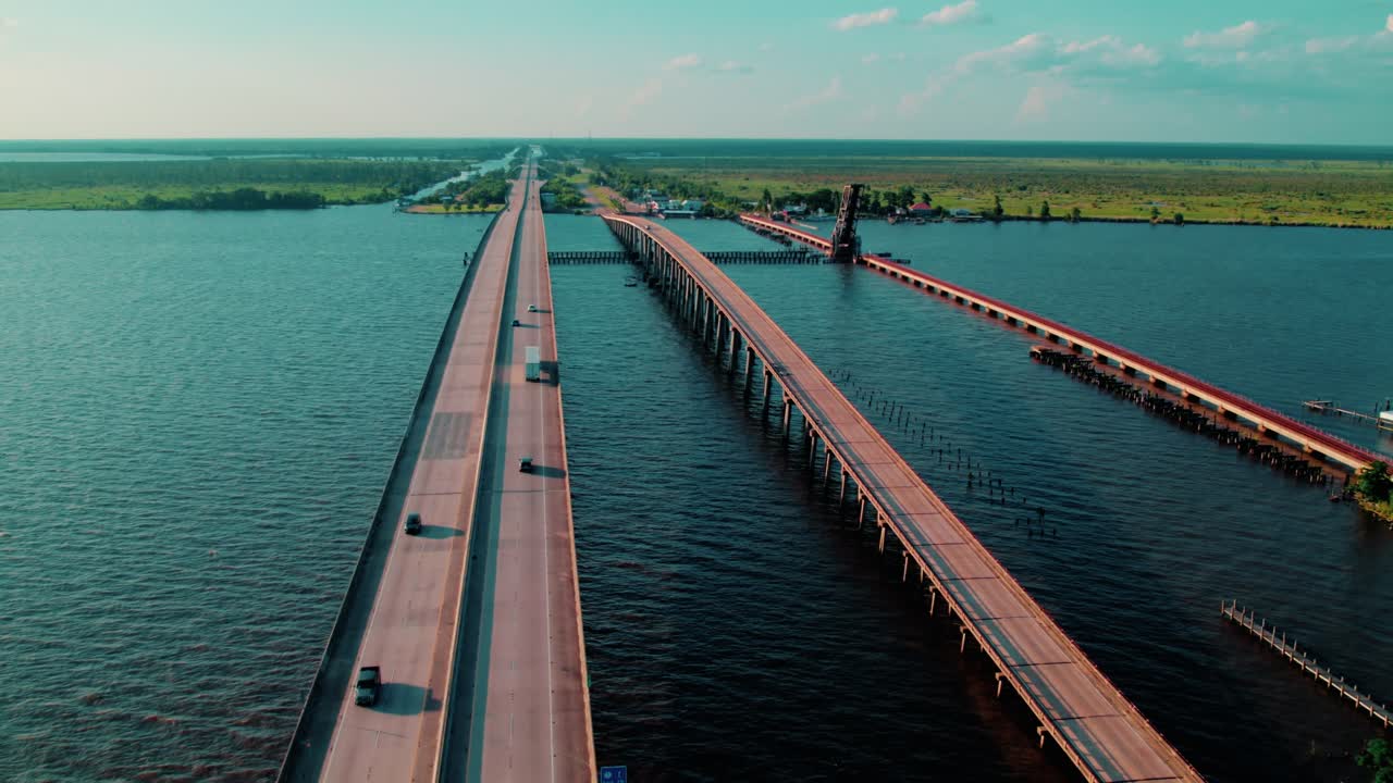 I-55 twin bridge system through Manchac Swamp near Akers, LA, with truck traffic and surrounding wetlands.