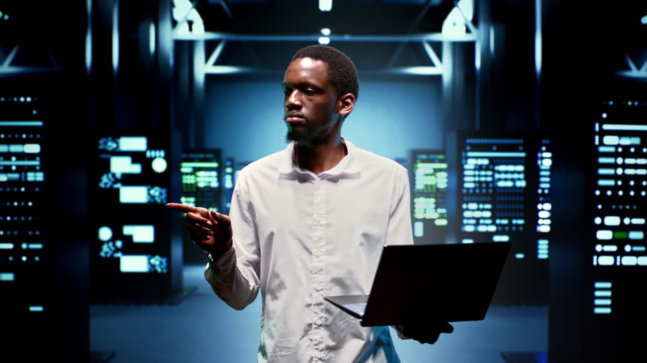 IT specialist walking between mainframes