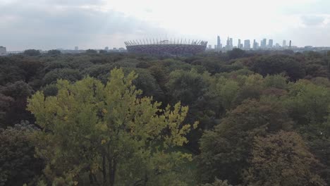 drone video of national stadium of poland with city and forest in the background on a cloud day