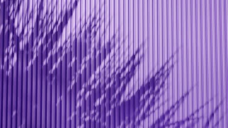 shadow of palm leaves on vertical purple corrugated metal wall. abstract natural light and line pattern background. design for wallpaper, banner, postcard, greeting card, poster, vertical