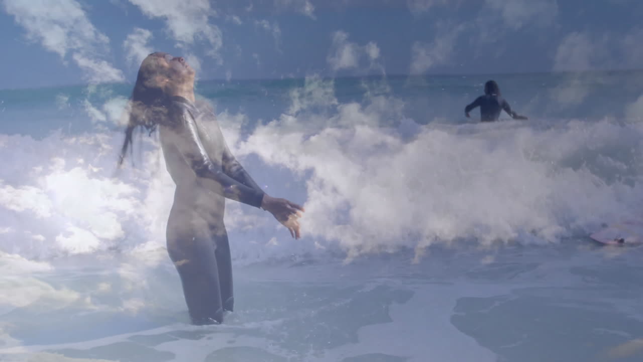 Friends paddling and flipping hair in ocean surf, with animated health data overlays