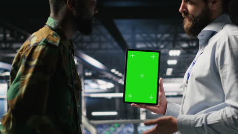 military personnel overseeing ai computing operations on isolated screen tablet