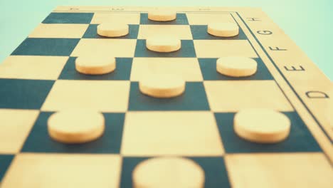 a wooden board of a draughts checkers strategy game, slow motion, close up shot, 4k