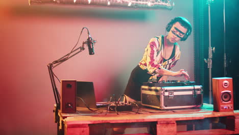 musical specialist mixing records at turntables on stage