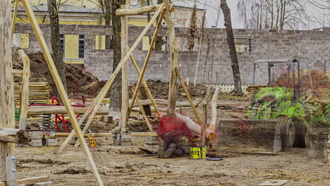 Motion-timelapse-of-a-young-male-builder-working-at-the-cottage-construction-site