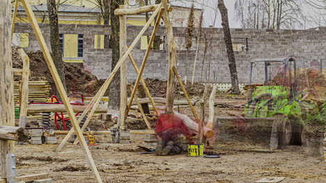 motion timelapse of a young male builder working at the cottage construction site