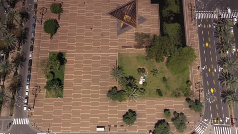 aerial view of a city square with monument and park