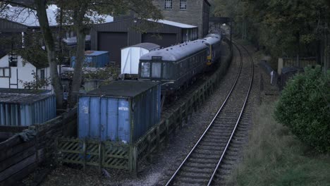 Empty-single-train-track-with-parked-carriages-view-from-bridge-wide-tilting-shot