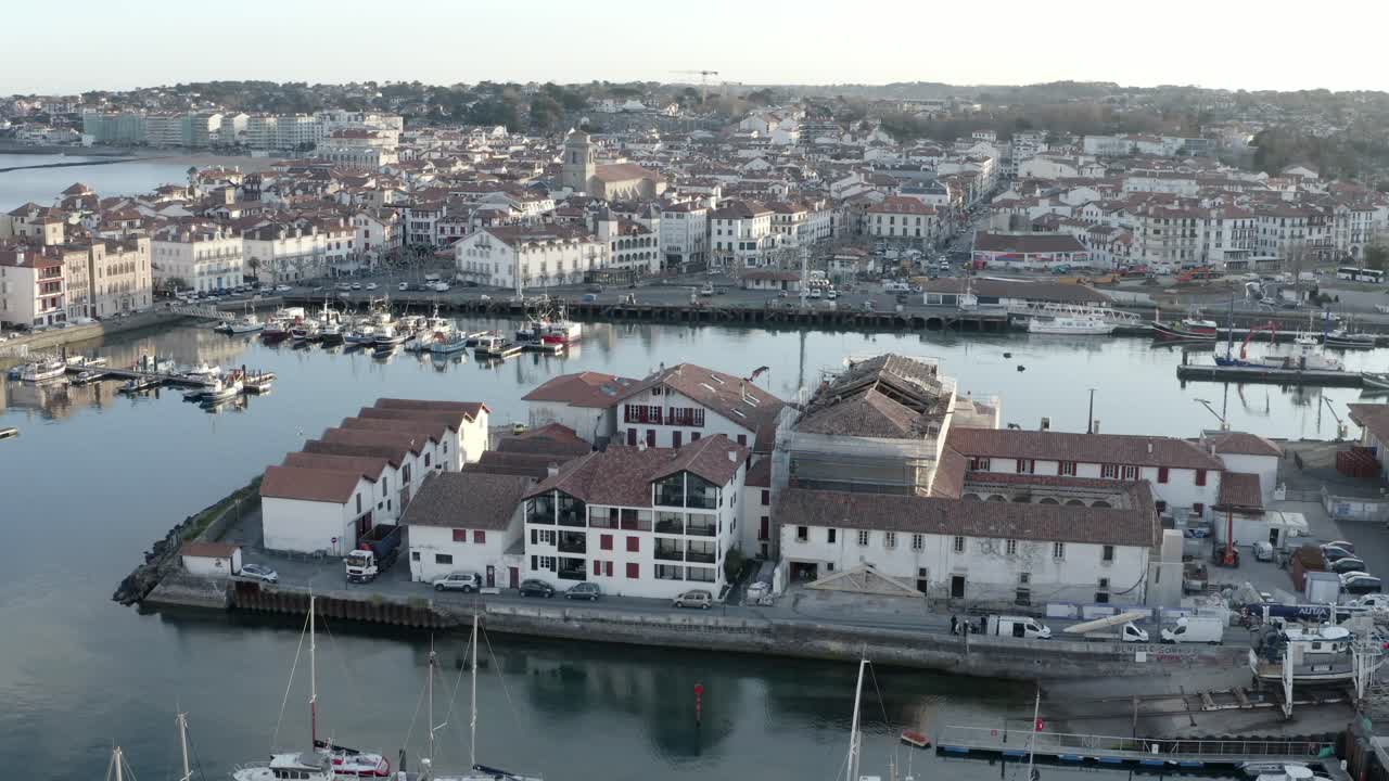 Saint-Jean-de-Luz harbor, boats, and town, France. Aerial drone view