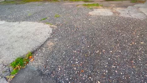 Close-up-of-worn-and-broken-asphalt