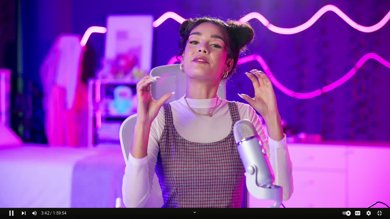 Woman with space buns talking into microphone