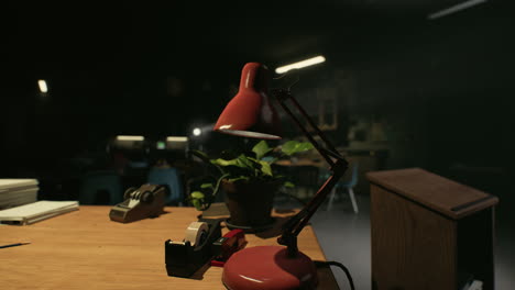 red desk lamp on a desk in a classroom