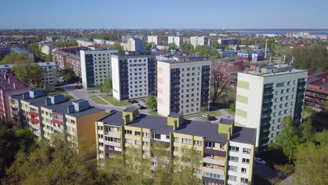 aerial view of crowded residential district apartment buildings on a sunny summer day, renovated and insulated houses, colorful walls of the facade, park, wide angle drone dolly shot moving right