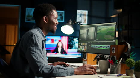 african american videographer works on editing film footage at home