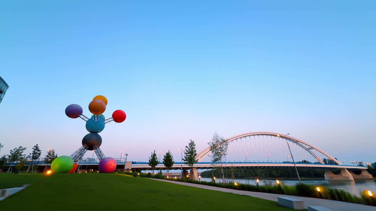 Contemporary art installation on the green lawn near the Danube. View on the Appolo Bridge in Bratislava, Slovakia