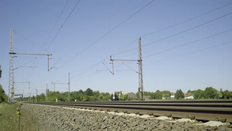 Yellow-train-speeds-past-on-a-sunny-day