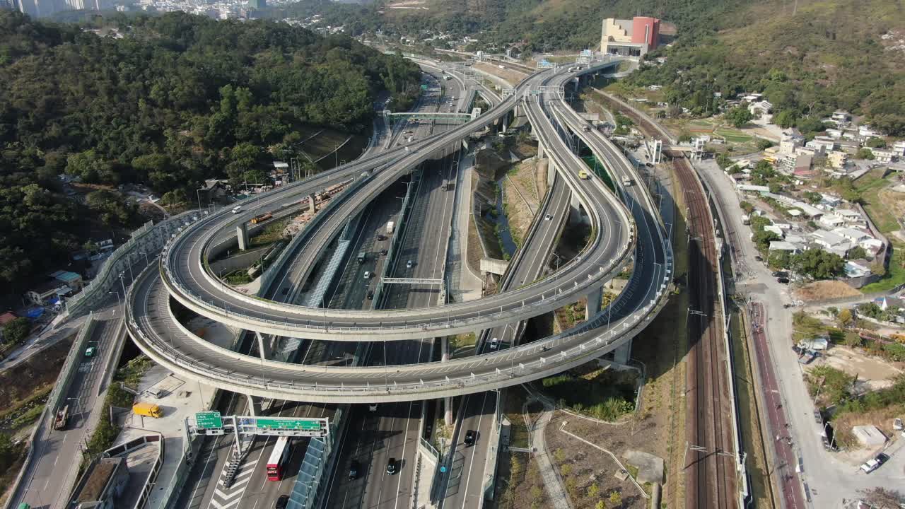 Traffic on a Massive highway interchange with multiple levels and loop shaped road in Hong Kong, Aerial view