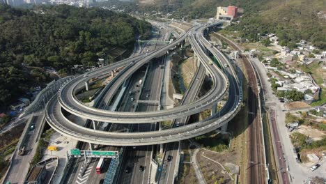 traffic on a massive highway interchange with multiple levels and loop shaped road in hong kong, aerial view