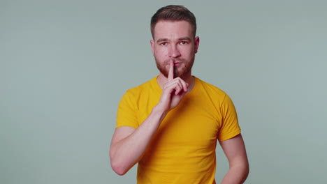 Man-presses-index-finger-to-lips-makes-silence-gesture-sign-do-not-tells-secret,-shh-be-quiet