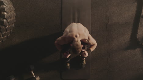 man performing sit-ups in a gym