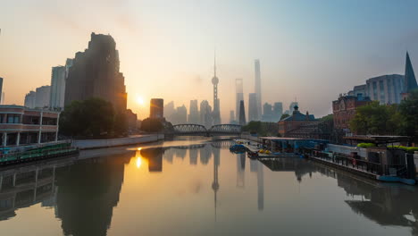 shanghai cityscape at sunrise with river reflection and iconic skyline