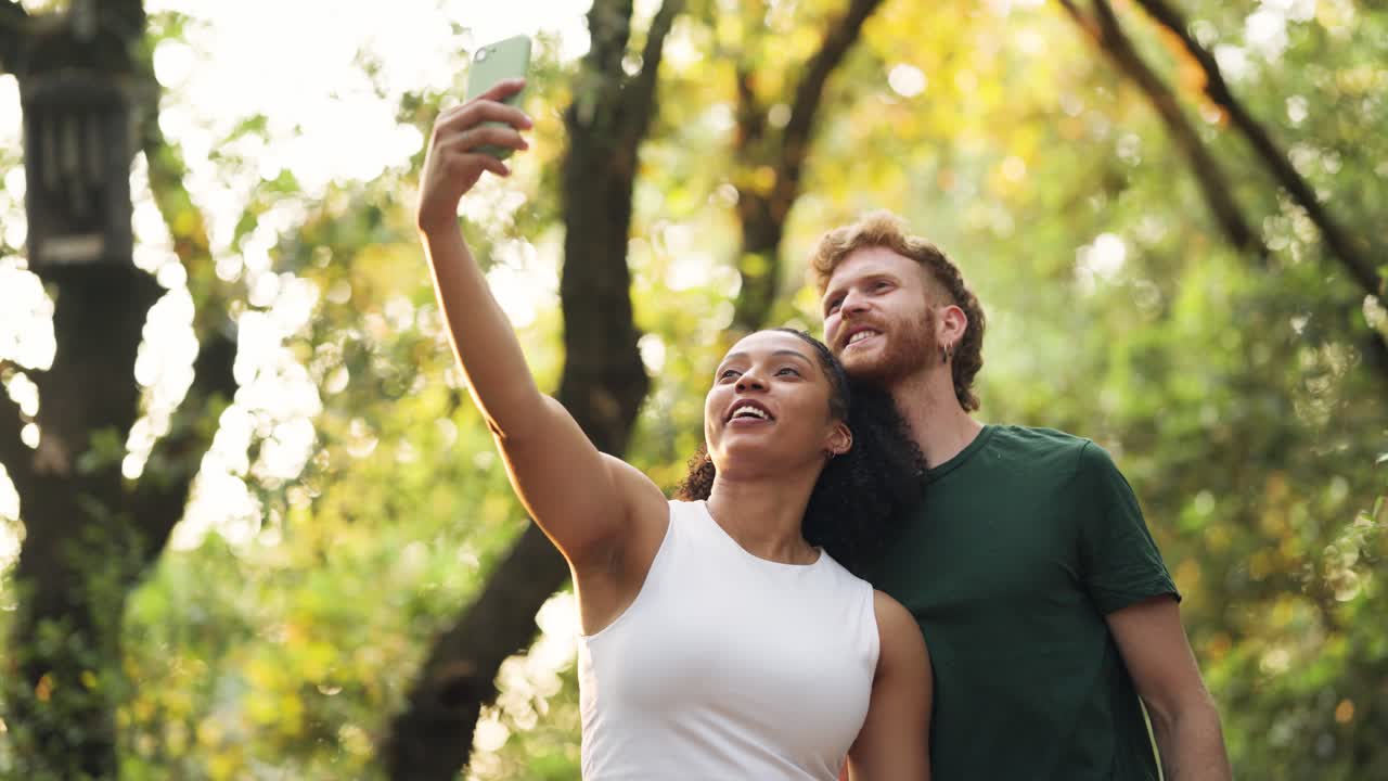 Couple taking a selfie in the forest