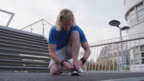 sporty caucasian man on a bridge