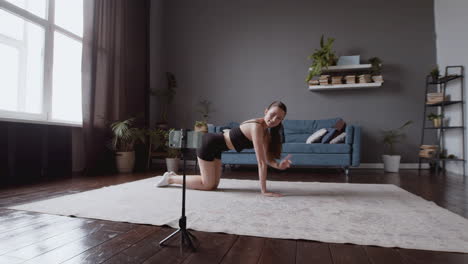 wide shot of an exultant athletic young woman giving an online fitness lesson