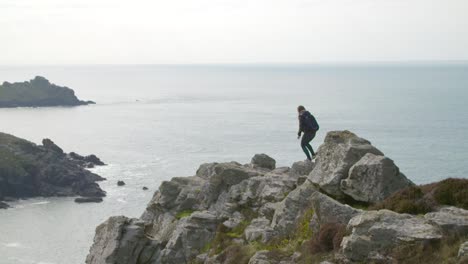 hiking along cliff edge in cornwall