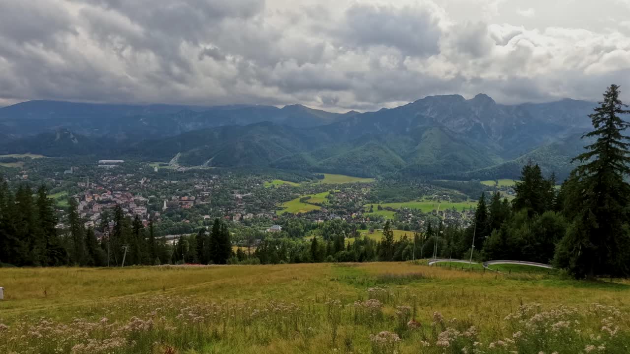 Timelapse of mountain peaks near Zakopane, Poland, during summer. Dramatic clouds drift over lush alpine landscape. Perfect for nature, travel, and cinematic outdoor visuals
