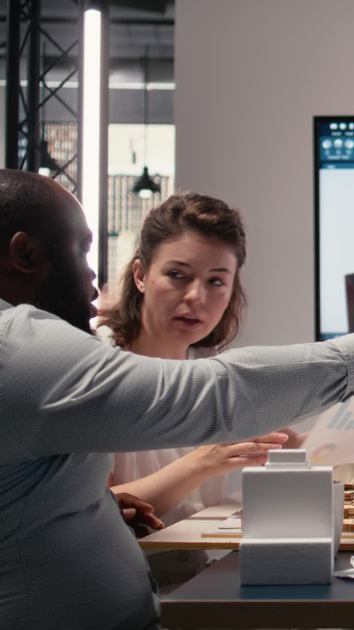 Vertical Video Diverse engineers team go over structural real estate city planning