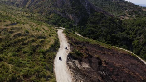 off-roading in the mountains on a gravel path aerial