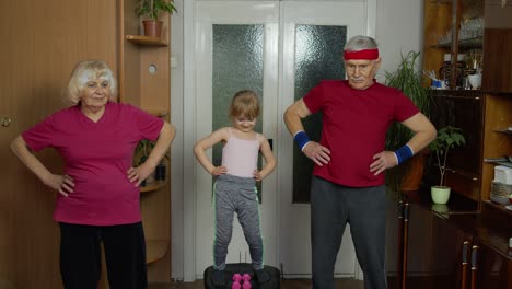 active senior couple grandmother grandfather with child kid girl doing fitness stretching exercises