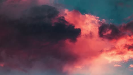 orange cumulus clouds moving across the blue sky