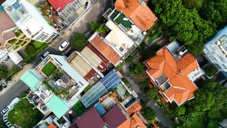 top-down drone shot of a residential district in ho chi minh city, vietnam, showcasing a mix of traditional houses, modern high-rises, and urban density.