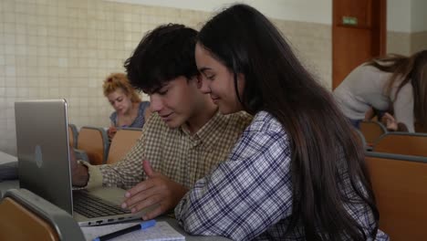 students working on laptop at class