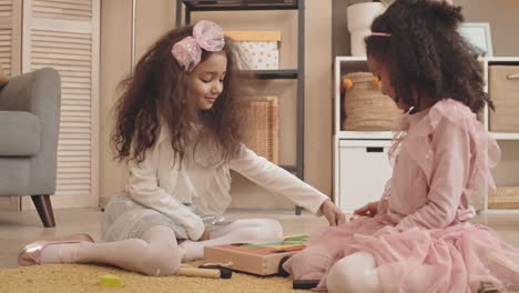 sisters playing with wooden toys