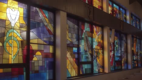 a wall of beautiful stained glass in a catholic church