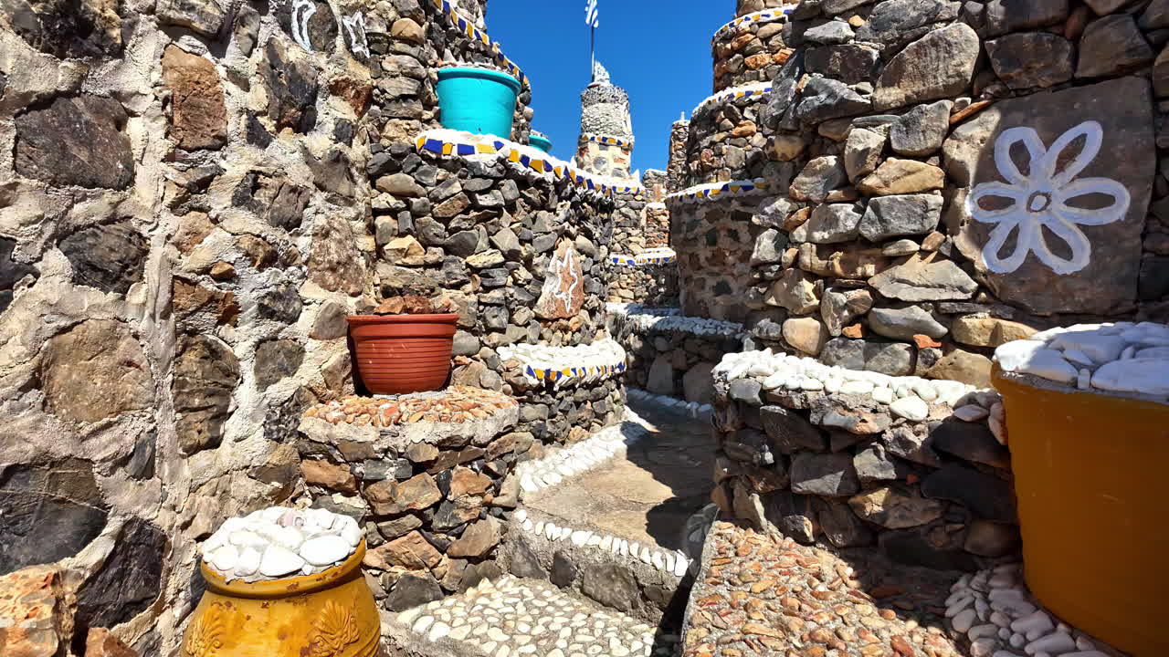 POV of stone museum in Greece with colorful pots, crosses and Greek inscriptions