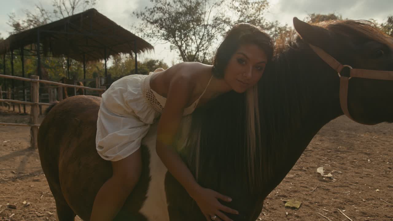 Woman bonding with her horse at a stable