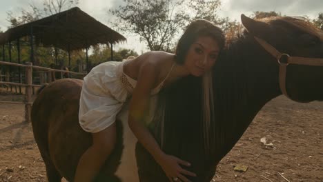 woman bonding with her horse at a stable