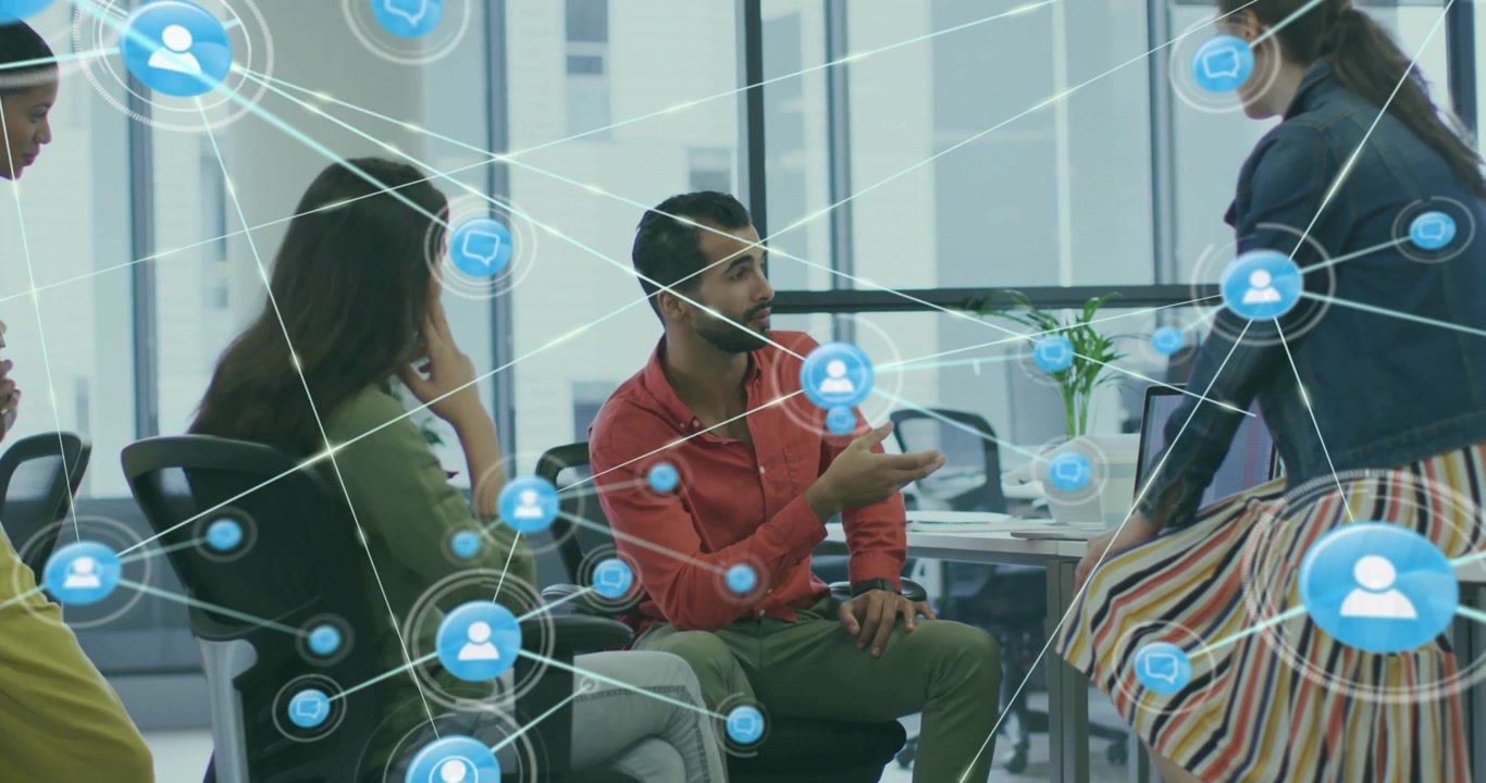 Colleagues discussing in business meeting area generating network icons showing collaboration