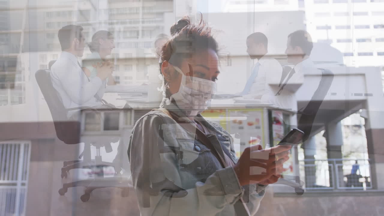 Woman wearing face mask using smartphone against office colleagues discussing in meeting room