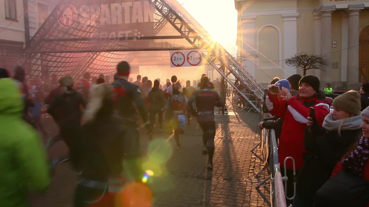 Spartan Race obstacle course run in Slovakia. Crowd of people running on road