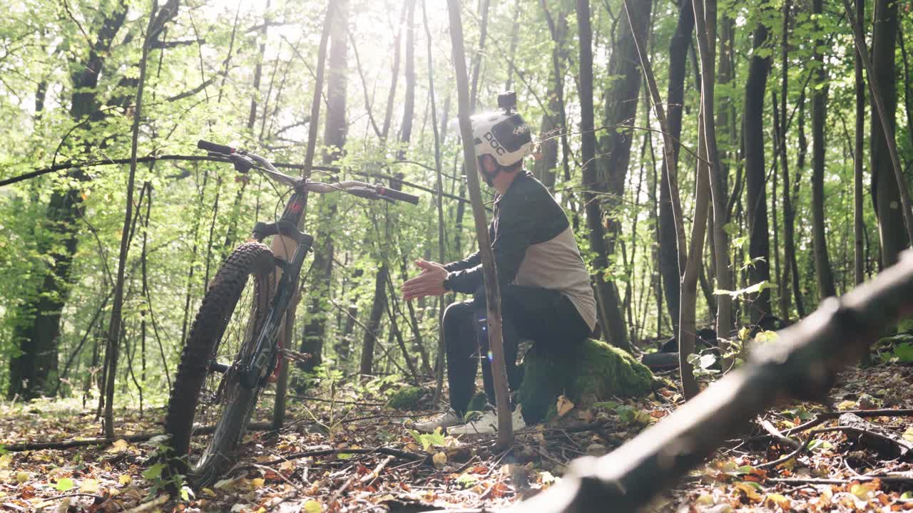 Mountain Biker Relaxing in a Forest