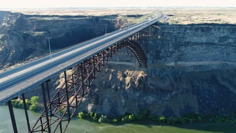 a 4k fly-over drone shot of perrine bridge, a 1,500 foot long bridge, spanning over the snake river in twin falls, idaho