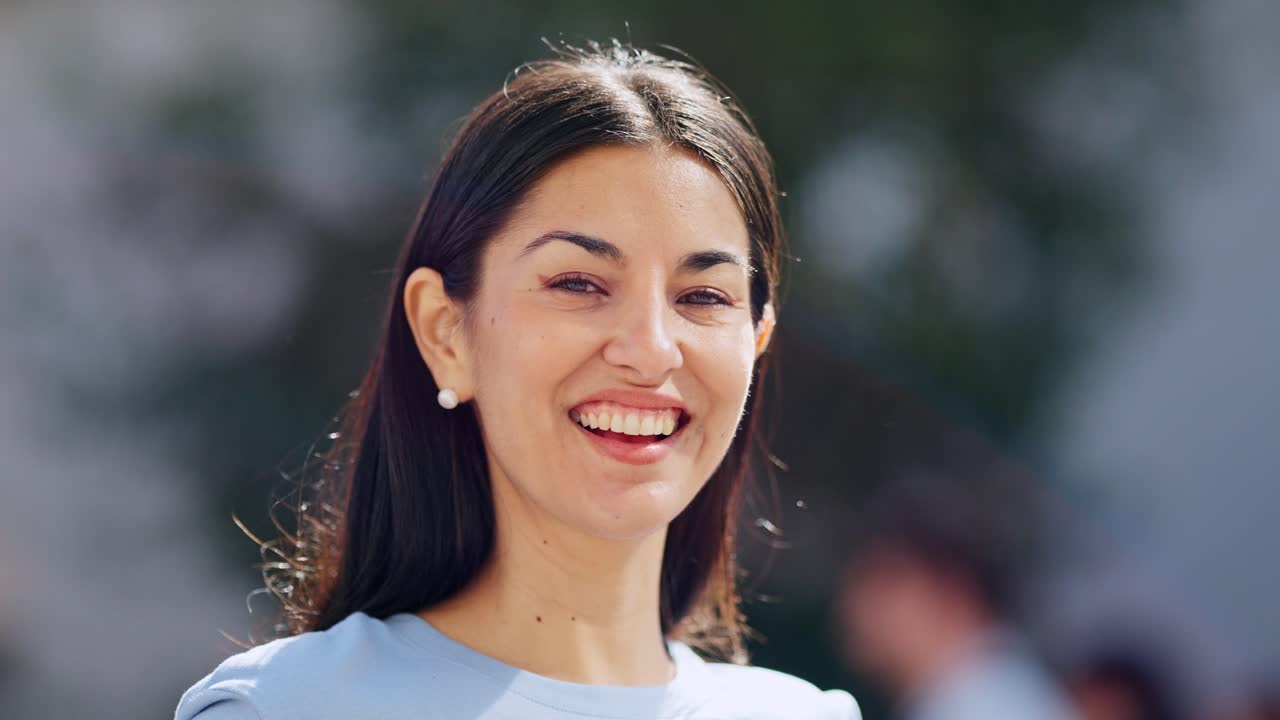 Close-up of a woman smiling and laughing